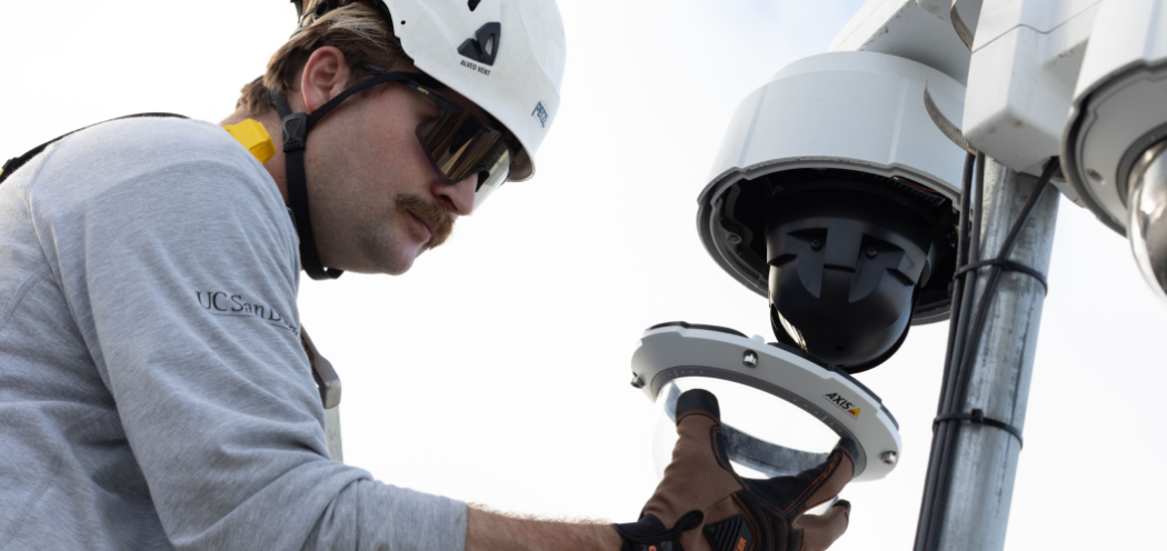 Worker repairing a surveillance camera